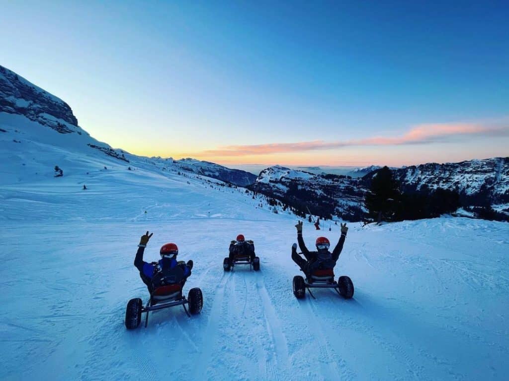 A family enjoys a mountain kart session in Flaine at sunset