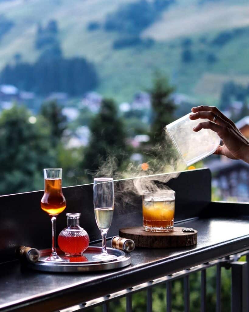 Cocktails are presented in front of the mountains
