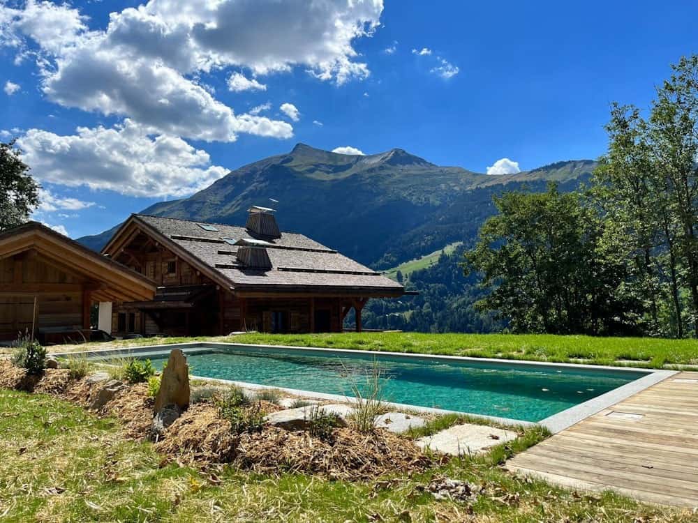 The outside pool at Chalet Beau Caillou, with a view of mountains