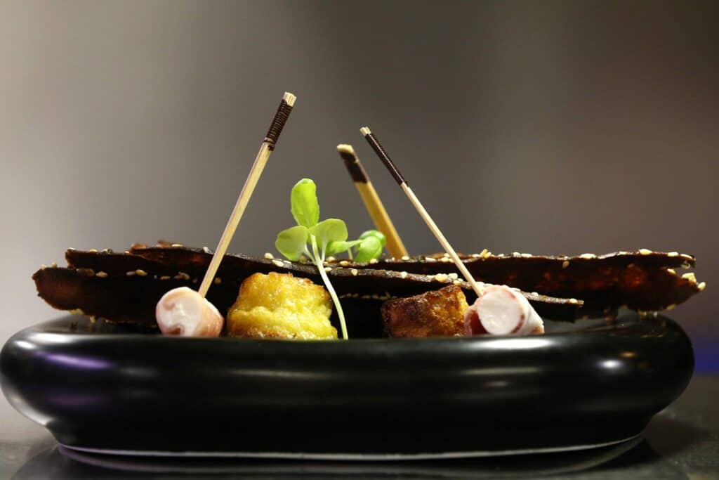A dish served with micro herbs and cocktail sticks
