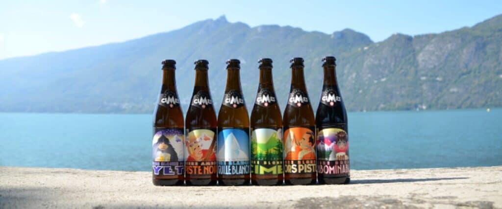 Six beers from the Brasserie des Cimes in Aix-les-Bains, on a wall in front of a lake