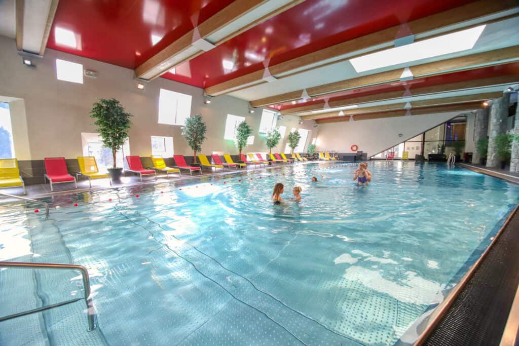 A family swim in an indoor swimming pool