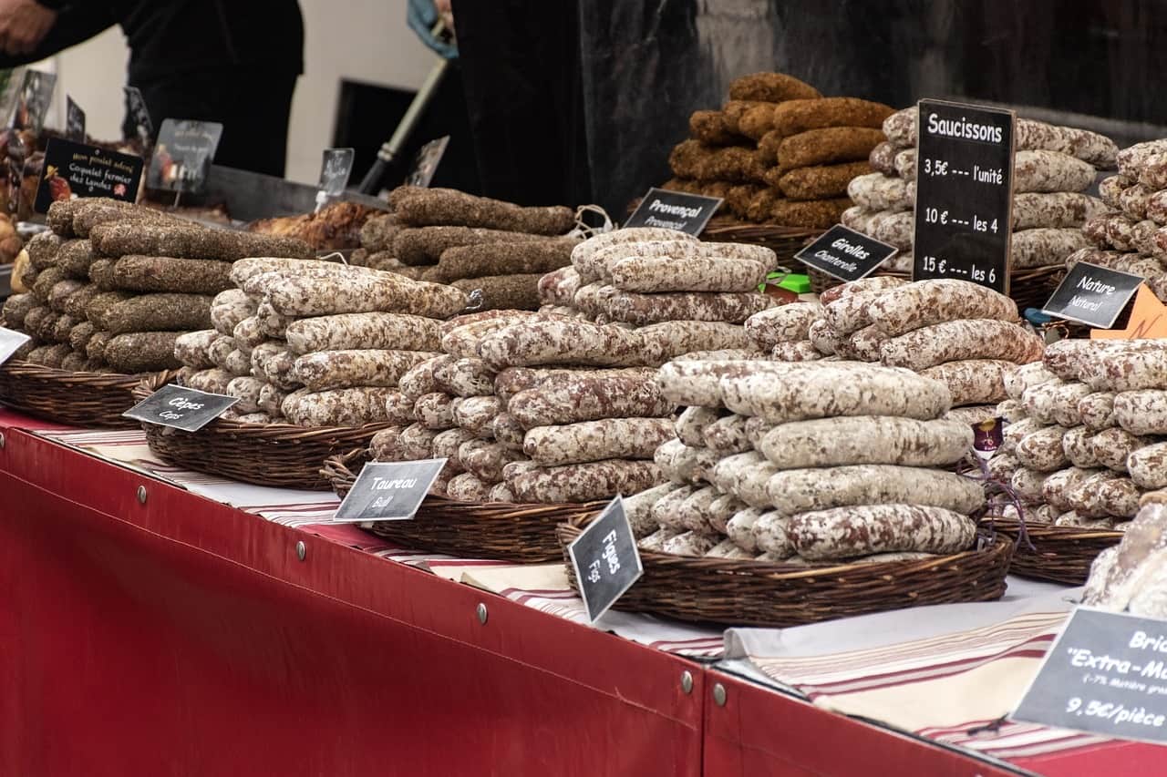 A market stall piled high with different varieties of salami