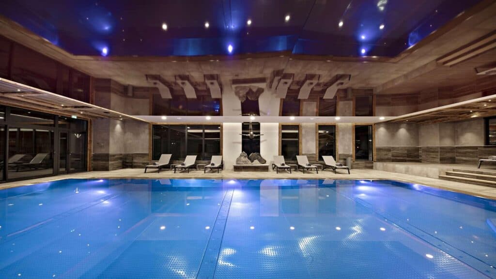 Spa swimming pool with deck chairs