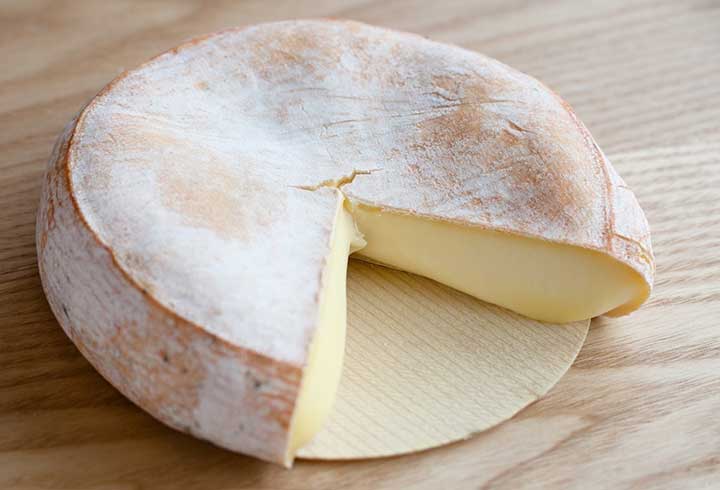 A creamy reblochon cheese, with a wedge removed