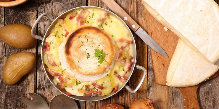 A delicious dish of tartiflette, with a Reblochon cheese melting on the top
