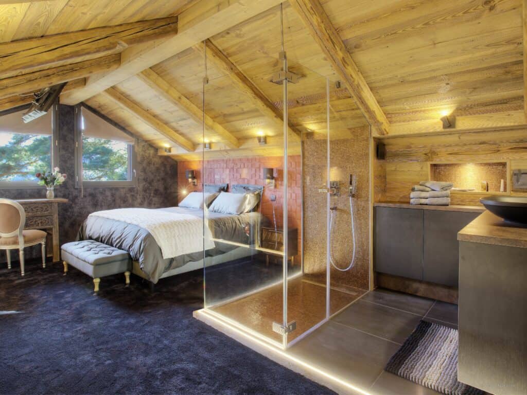 One of the bedrooms at Chalet Kalyssia, Annecy, with a glass walk-in shower