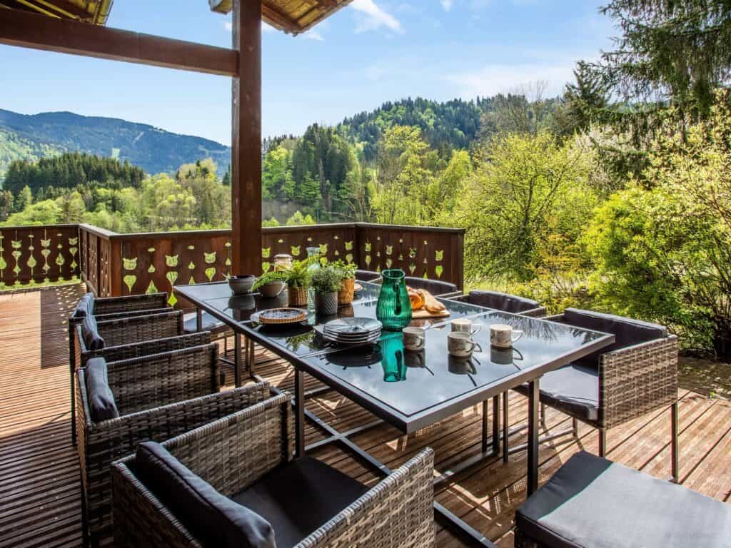 A dining table on a shady terrace at chalet Isla de Lux