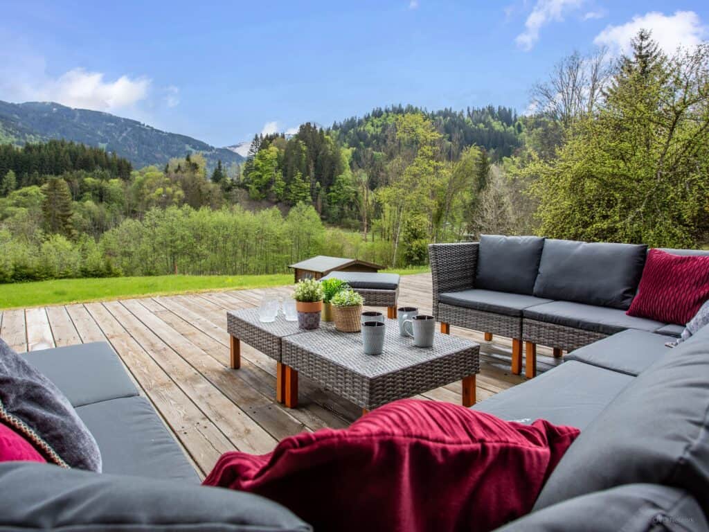 A large terrace with comfortable seating and mountain views
