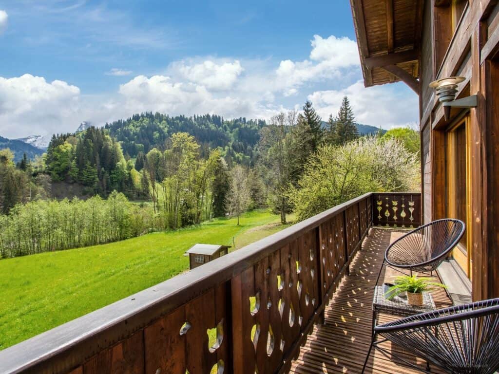 A wooden balcony with mountain views