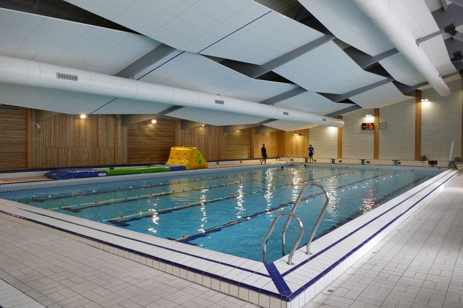 An indoor swimming pool with inflatables and swimming lanes