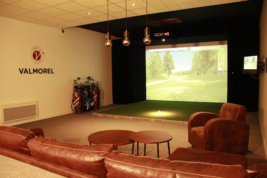 Indoor golf room in Valmorel with large screen TV and sofas