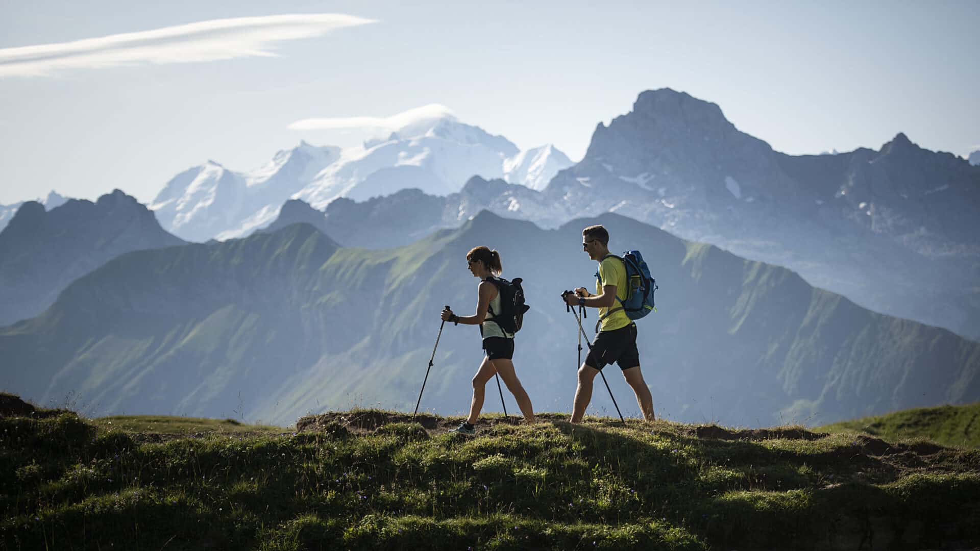 Two people using walking poles on a hike in the Aravis mountains
