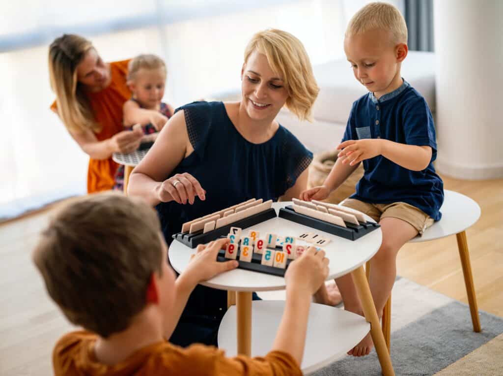 A family with young kids play games at on a coffee table