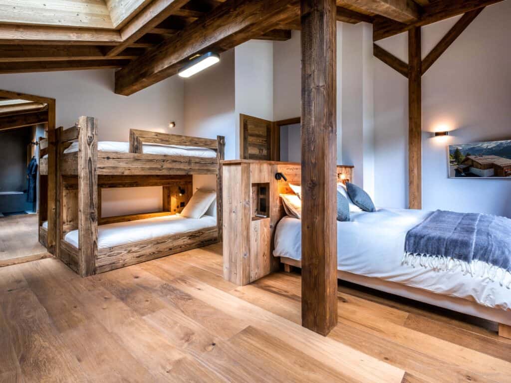 Family suite with exposed wooden beams at La Ferme de Mila, St Jean de Sixt