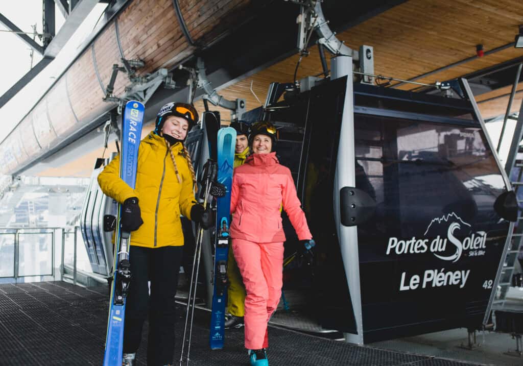A family of three step off a Morzine lift