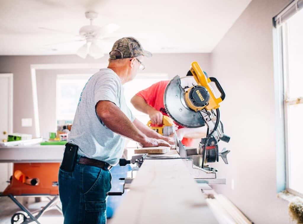 Two carpenters at work in a kitchen