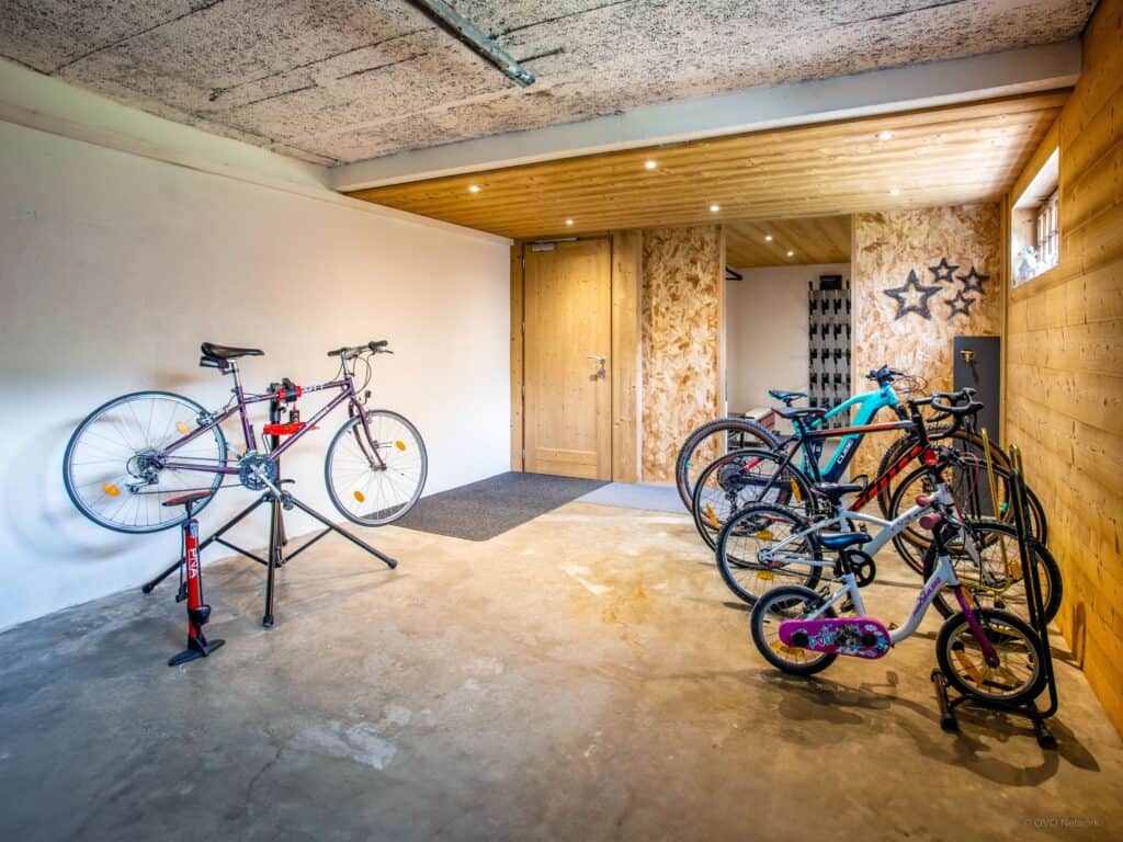A bike storage area with racks and a pump