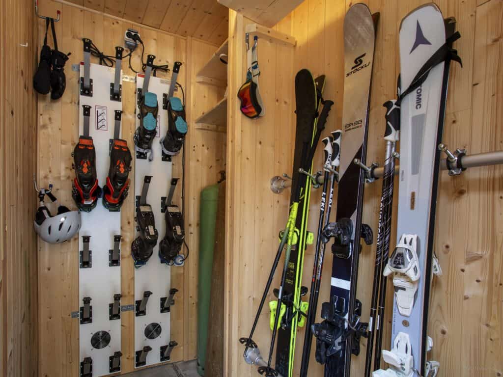 A ski store with ski racks and a heated boot rack