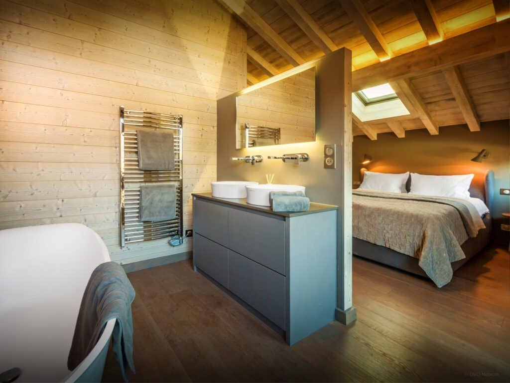 A double bedroom with sloping ceiling and a bathroom