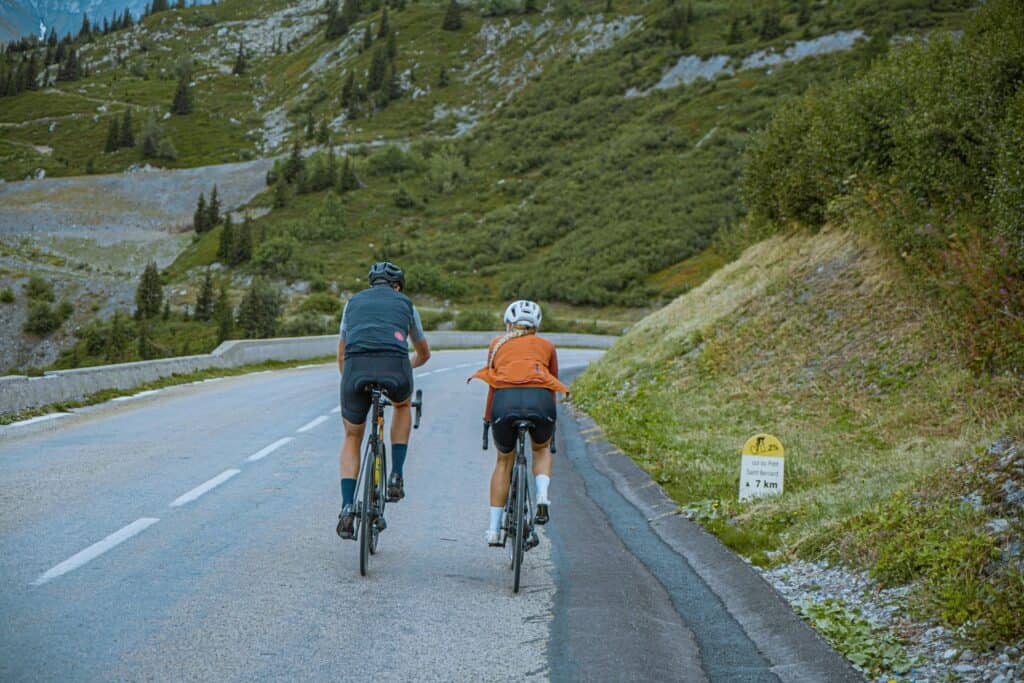 A couple cycle down a mountain passage