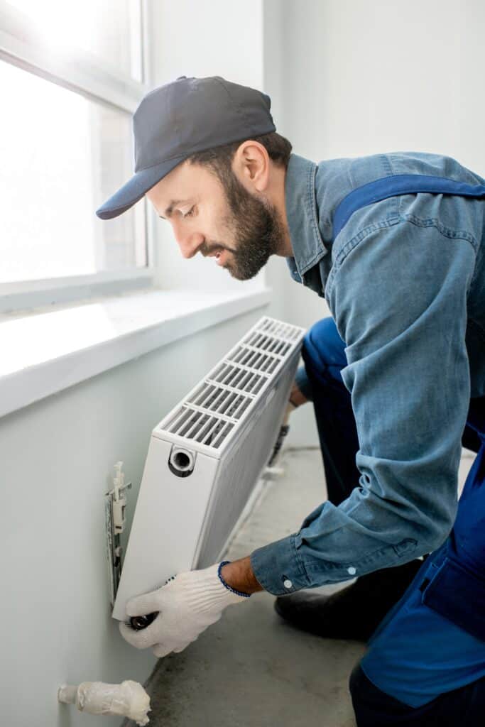 Workman replaces a radiator