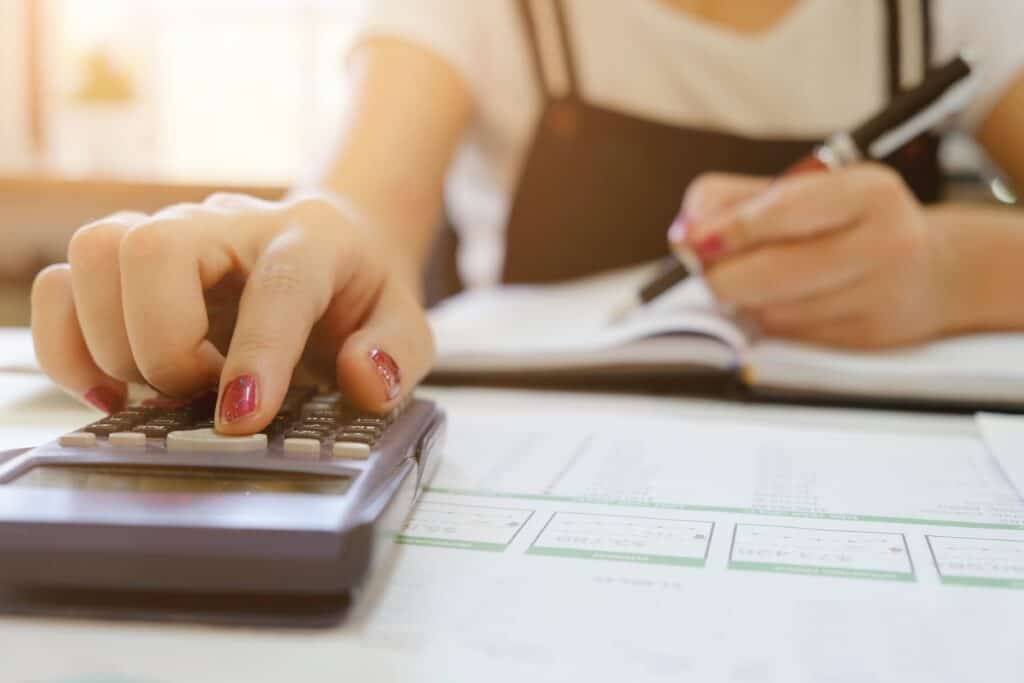 A woman uses a calculator
