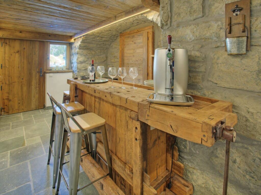 Bar stools at a wooden bench for wine tasting