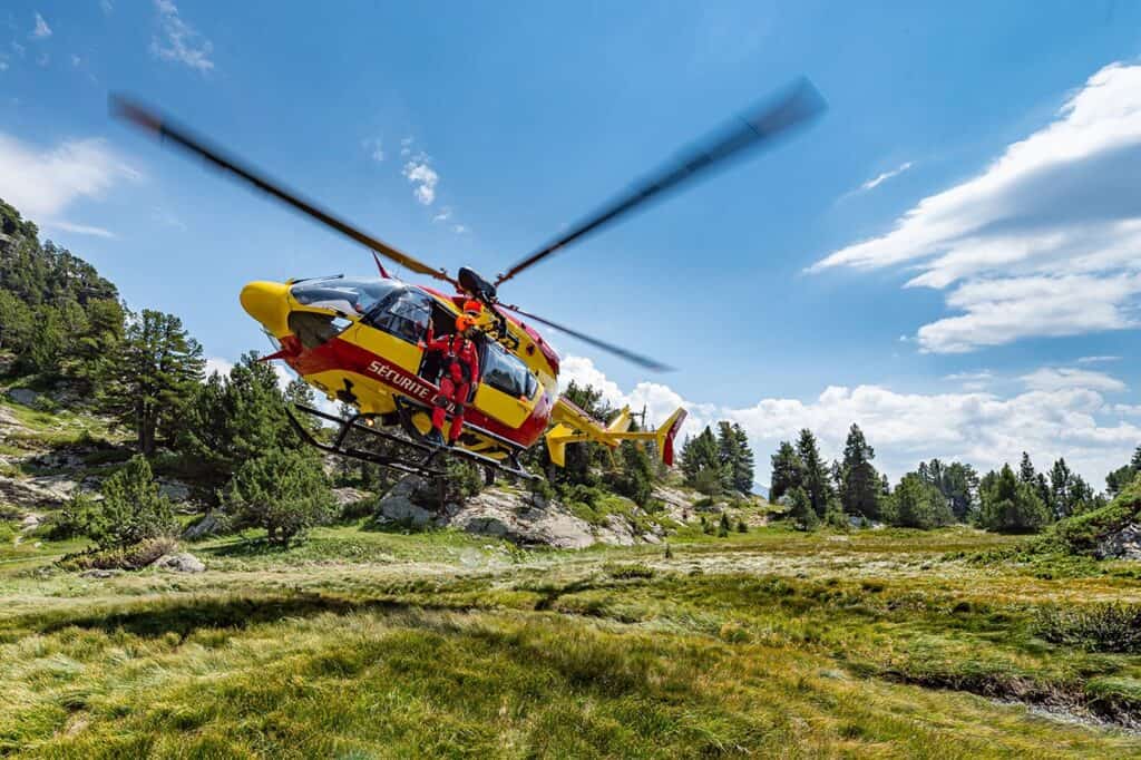 A rescue helicopter lands in the mountains