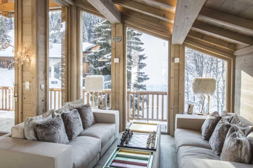 A bright living area with glass doors looking on to the mountains