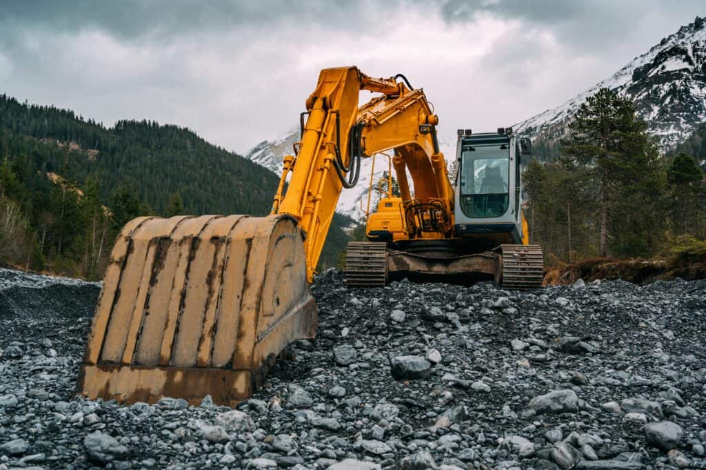 A digger with a mountain in the background