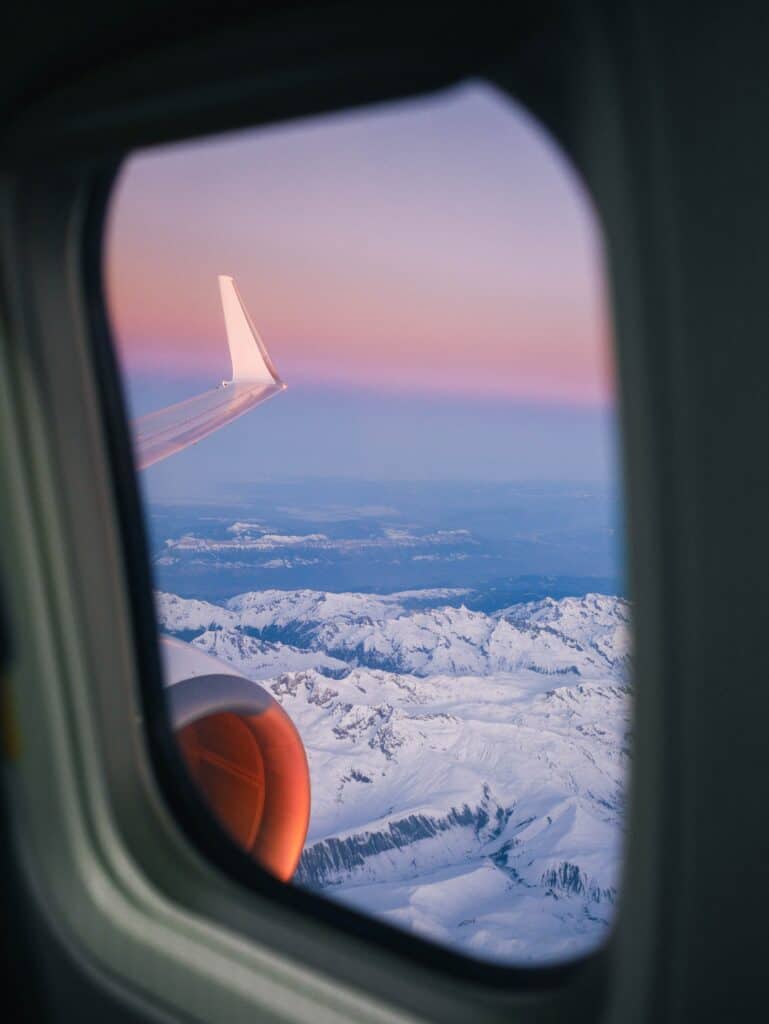 View of snowy mountains from an airplane window