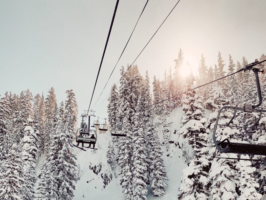 A chairlift set against a snowy background