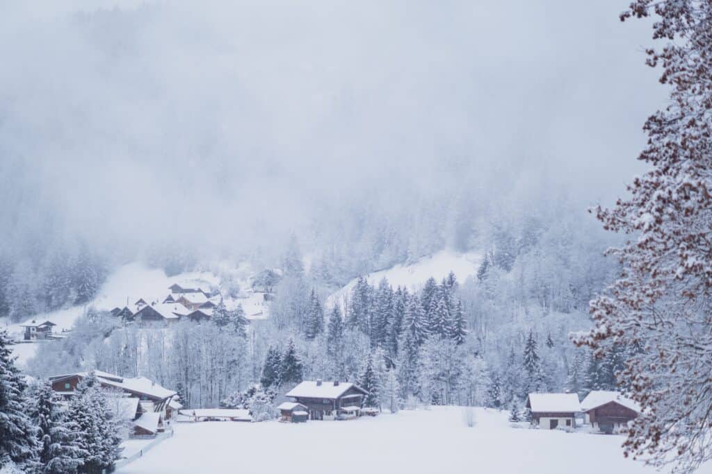 Les Contamines covered in snow with trees and chalets
