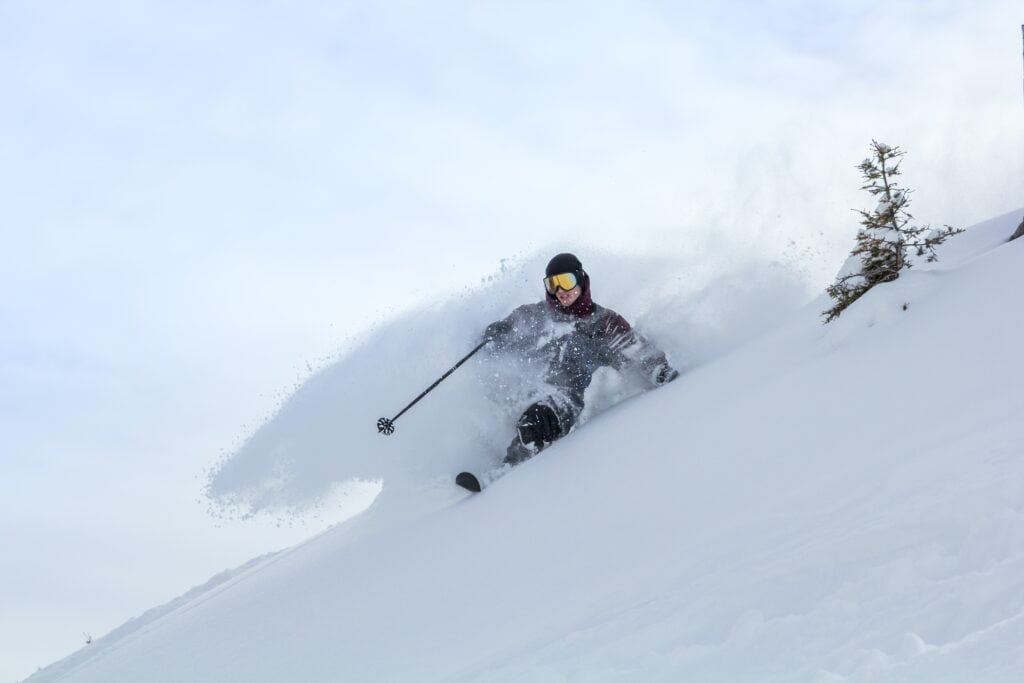 A man skis through powder