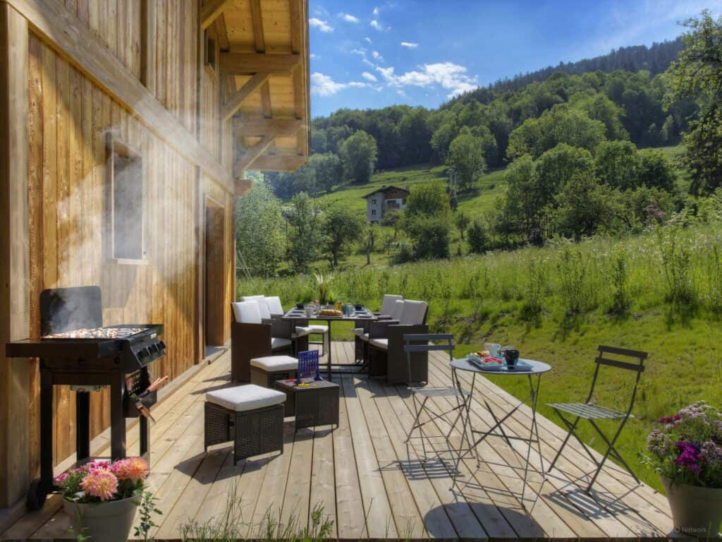 Chalet exterior with sun deck and outdoor furniture