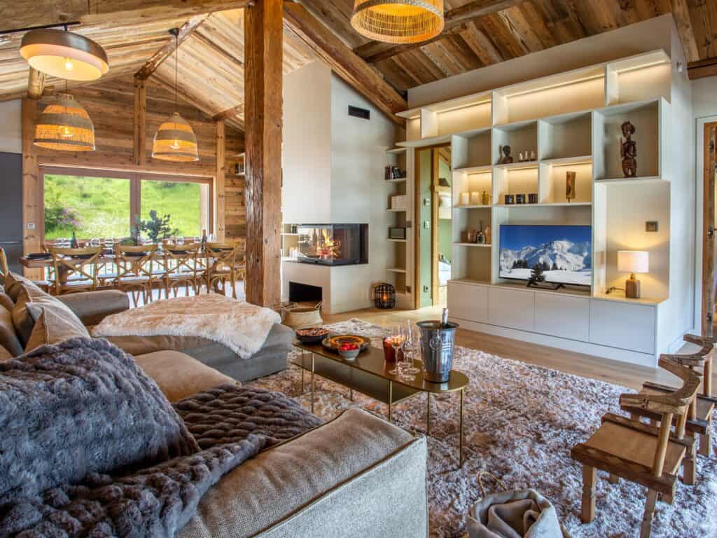 A modern alpine living room with fireplace and furry throws