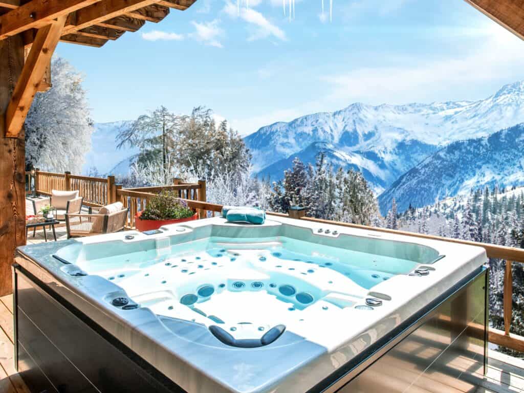 Winter hot tub with snowy mountains in background