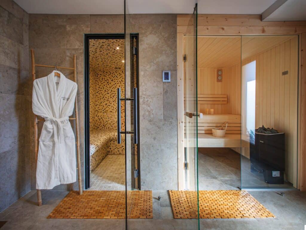 A sauna and hammam spa area with a robe hanging on a bamboo ladder