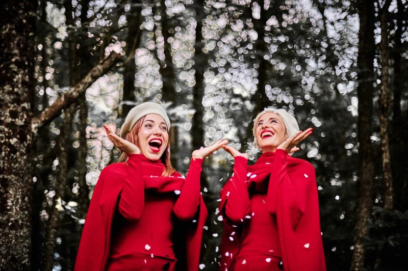 Two women in red jackets in the woods