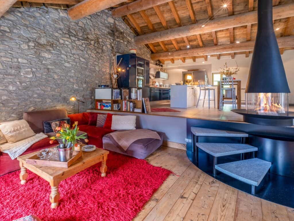 Large living area with lounge, kitchen and dining room in a chalet.