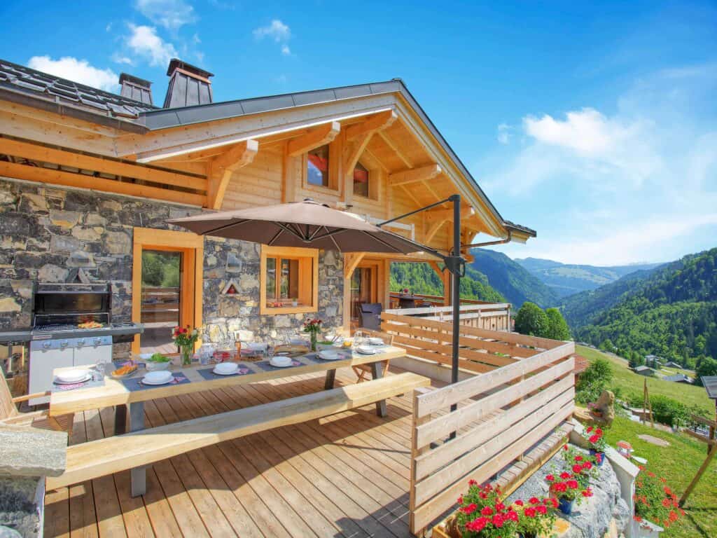 A summer chalet with decking and outdoor furniture