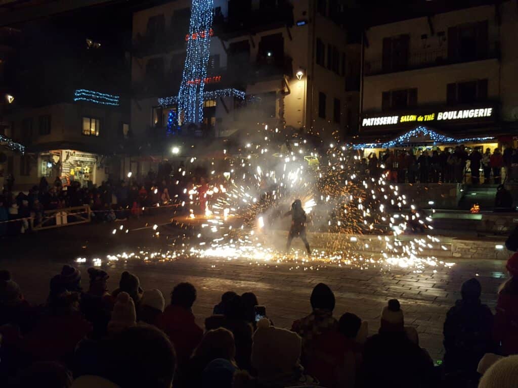 A person performs on the street using fire
