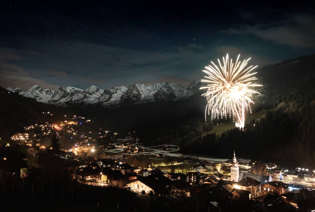 Fireworks explode over mountains
