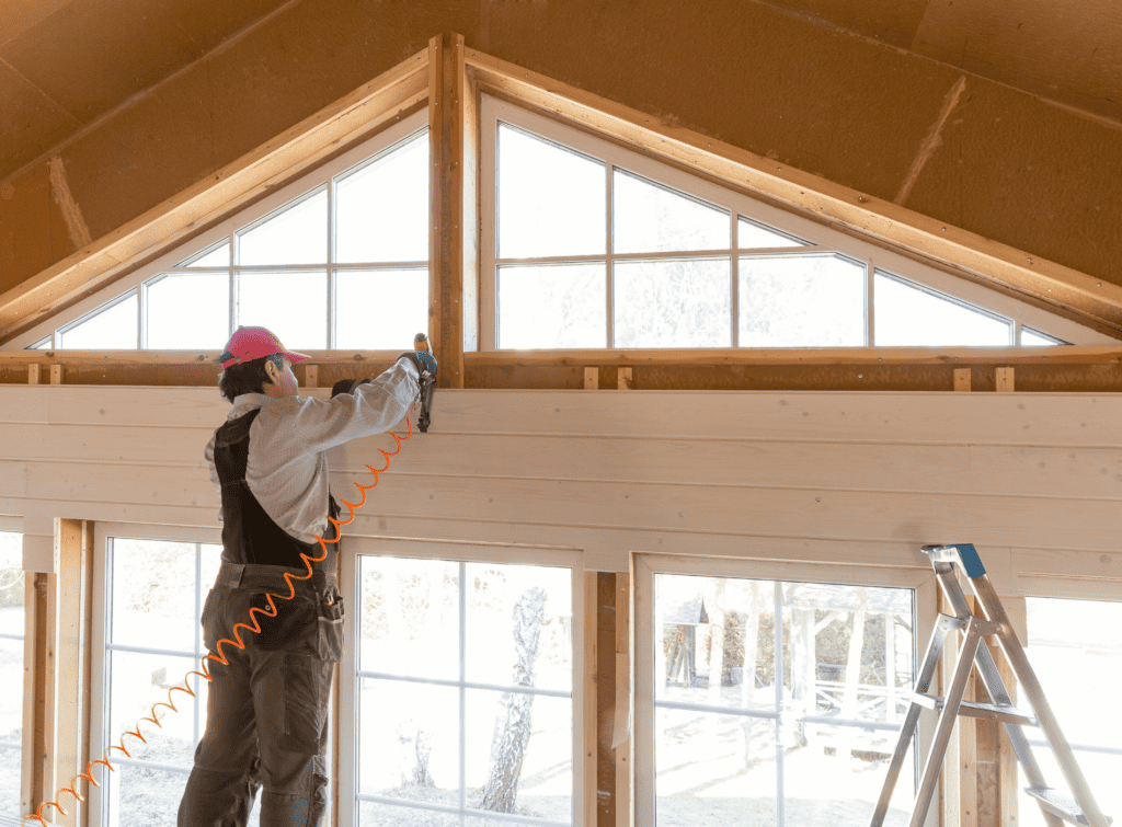 A builder works on the construction of a chalet