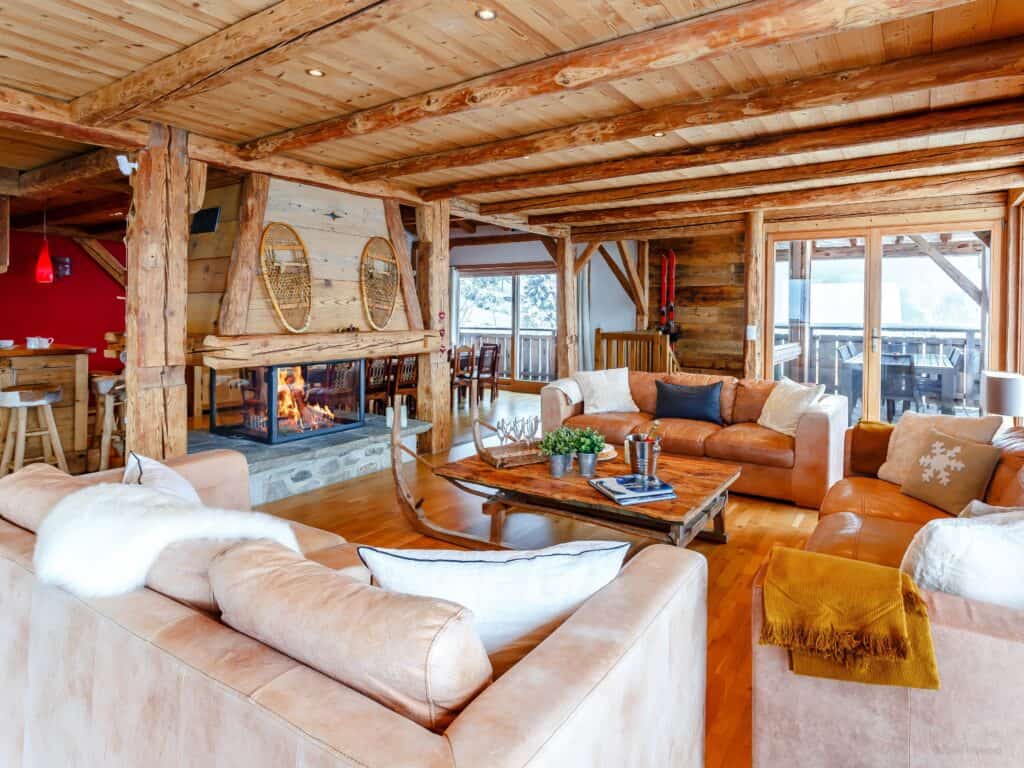 An open-plan living and dining area set around a central fireplace