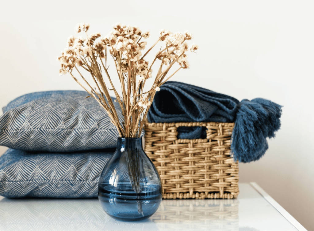 Cushions, throws and a vase of dried flowers