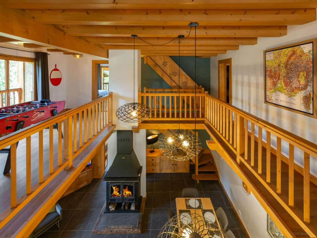 Inside Chalet Nahuel Huapi, with a chimney and a table football.