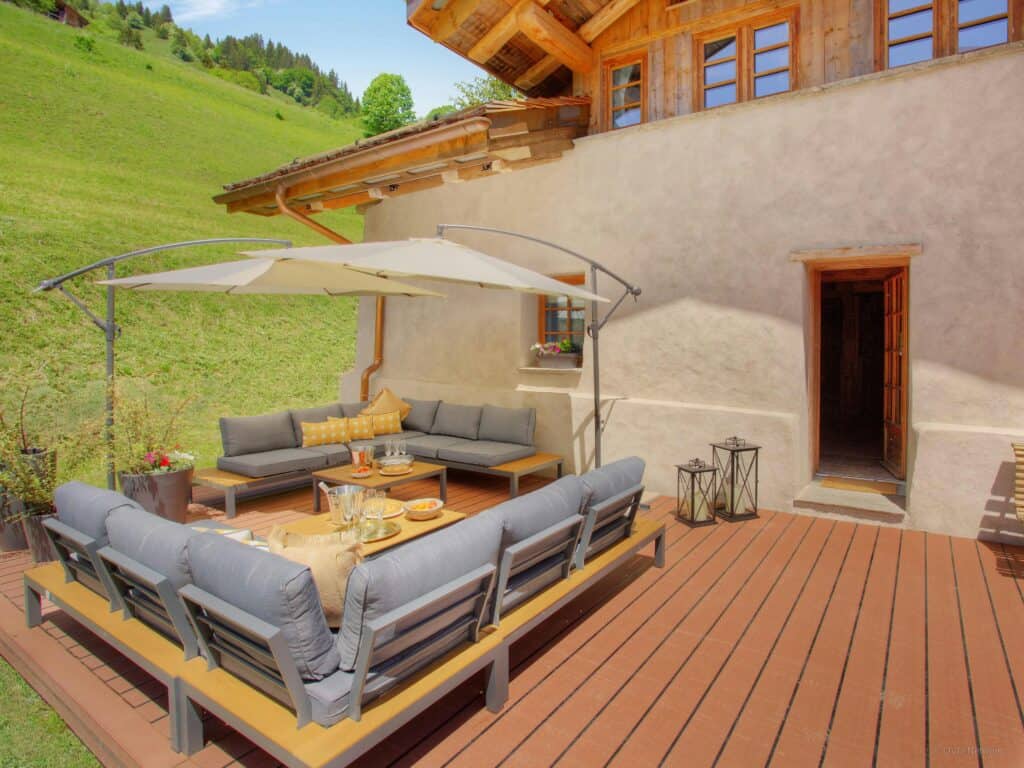sun deck with dining area overlooking green mountain fields