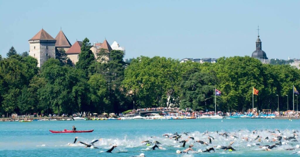 Participants of Annecy's triathlon swim in the lake